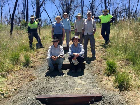 Work crew of volunteers from Friends of Lobethal Bushland Park Group and Adelaide Hills Council staff working on repairing steps.