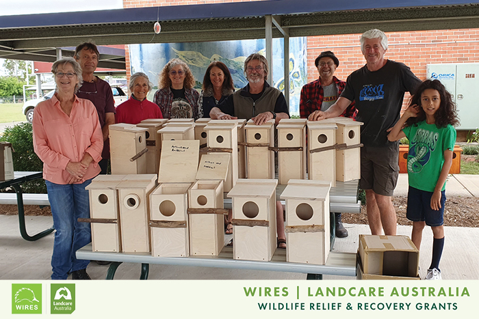 Volunteer Group Standing With Nestboxes