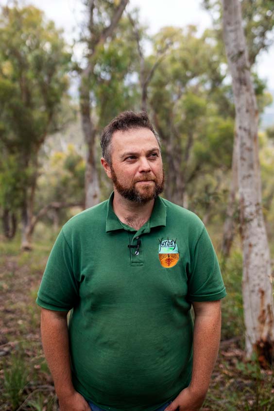 Adam Shipp standing in a eucalyptus forest