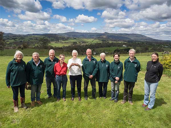Newham and District Landcare Members standing in a grassy field