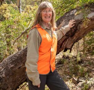 Liz Milner in a high vis vest in the field